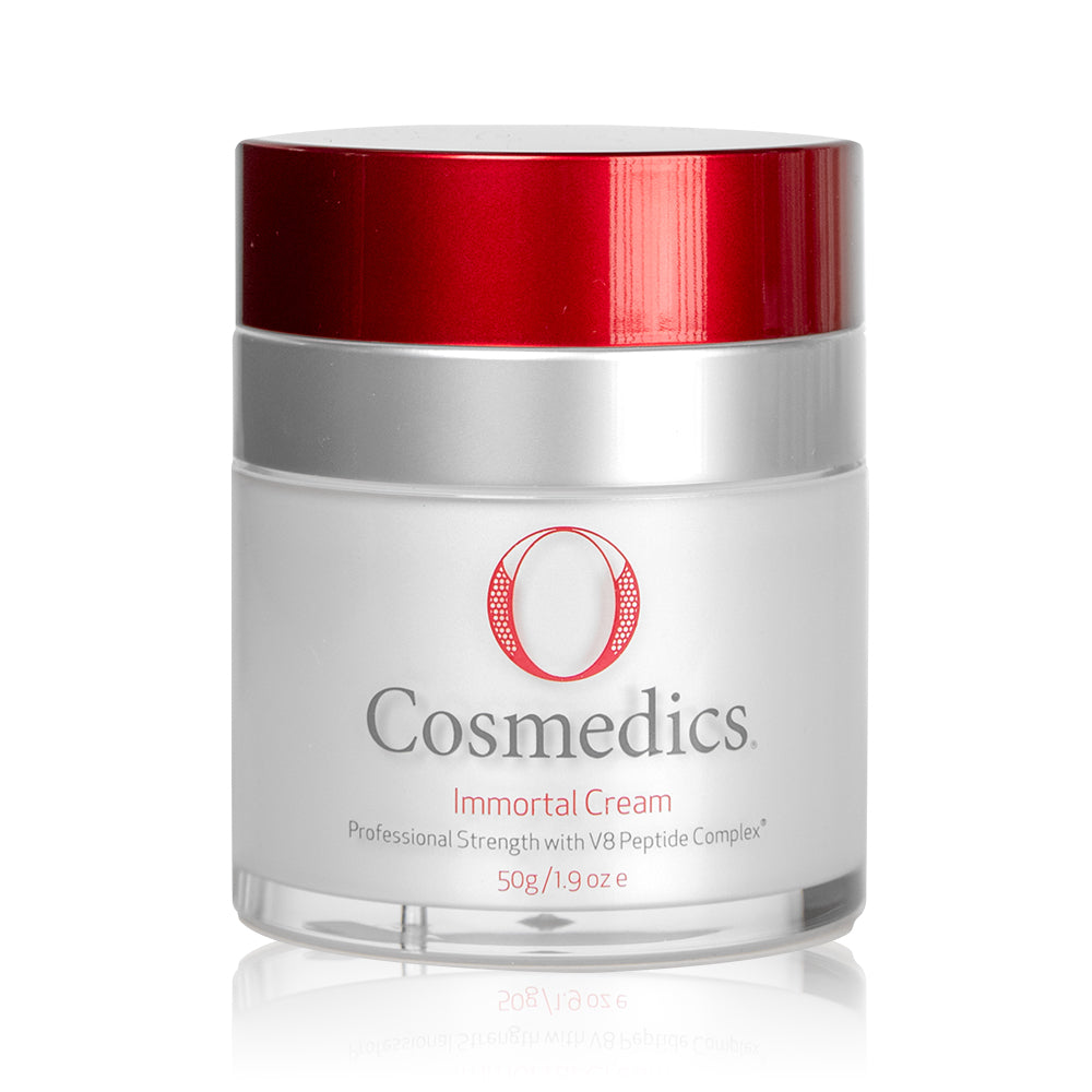 O Cosmedics Immortal Cream container with red lid in front of white background