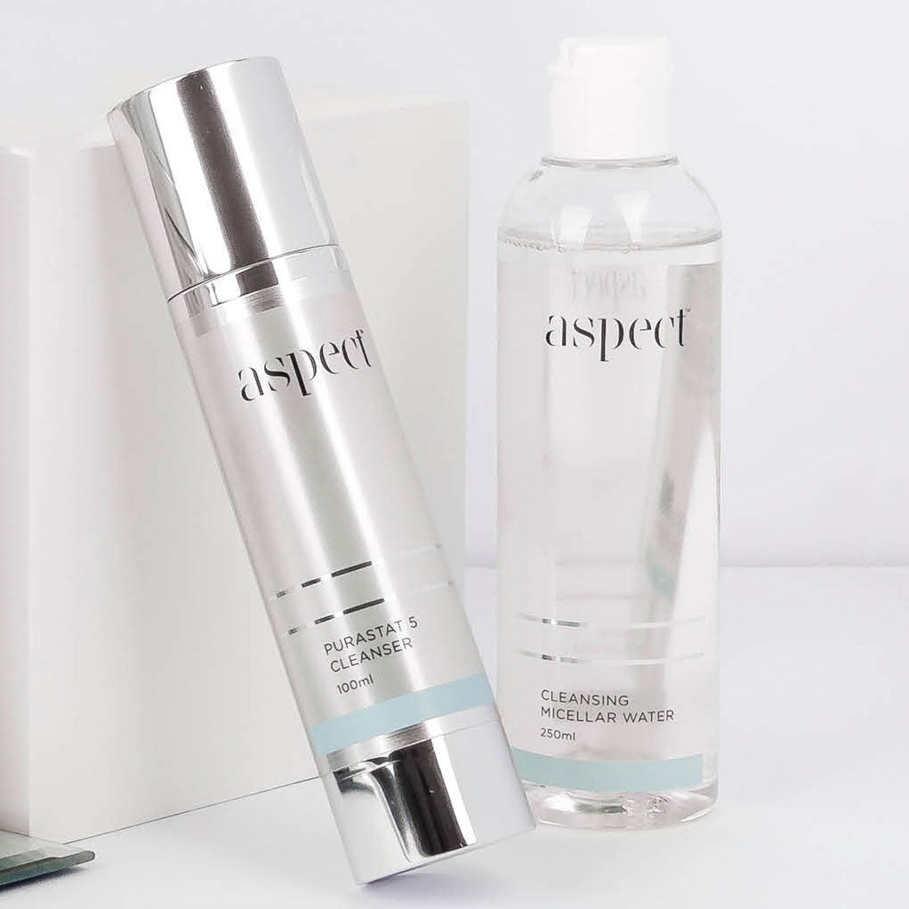 Container of aspect skincare purastat cleanser next to container of aspect skincare cleansing micellar water