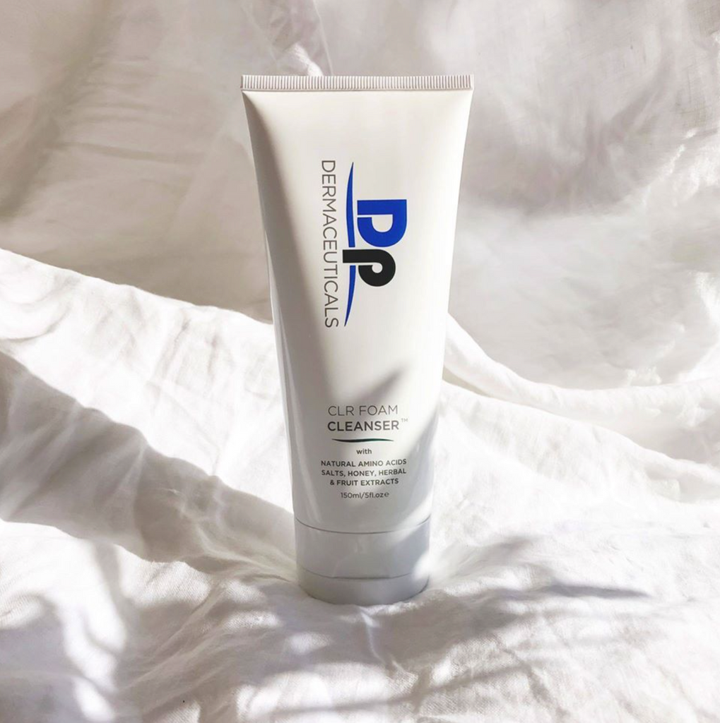 DP Dermaceuticals CLR Foam Cleanser in white container in front of white sheet