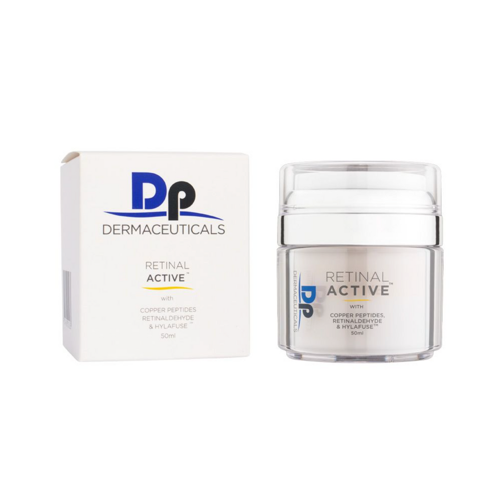 Dp dermacueticals retinal active cream in clear container with silver lid next to white packaging box in front of white background