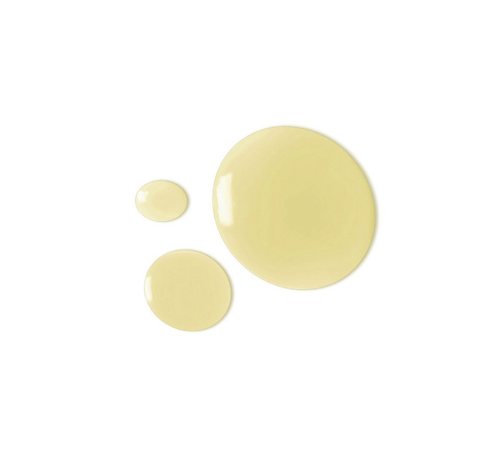 three yellowish globules of liquid on a white surface