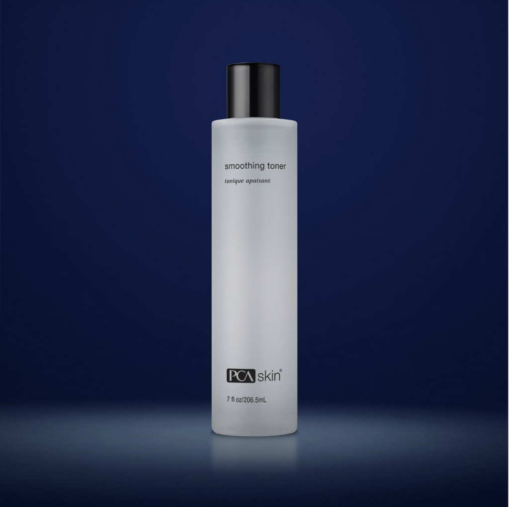 PCA Skin smoothing toner in white container with black lid in front of dark blue background