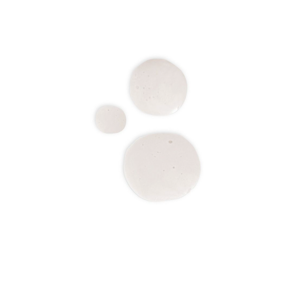 Three globules of milky globes on white surface