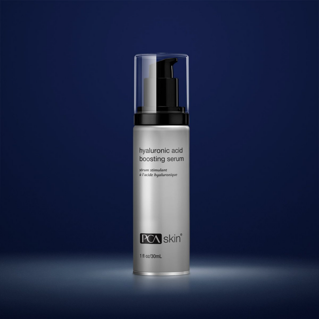 PCA Skin hyaluronic acid boosting serum in grey container with black lid in front of dark blue background