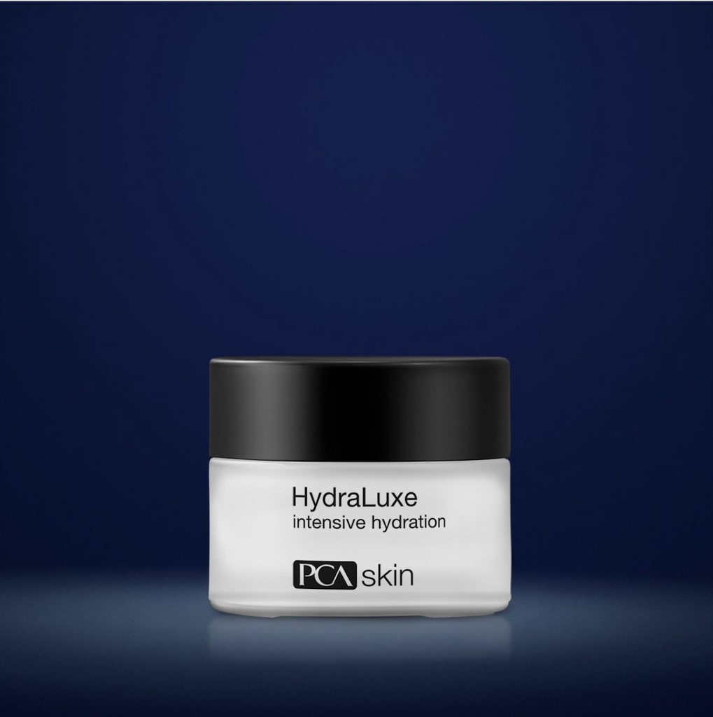 PCA Skin hydraluxe intensive hydration in white container with black lid in front of dark blue background