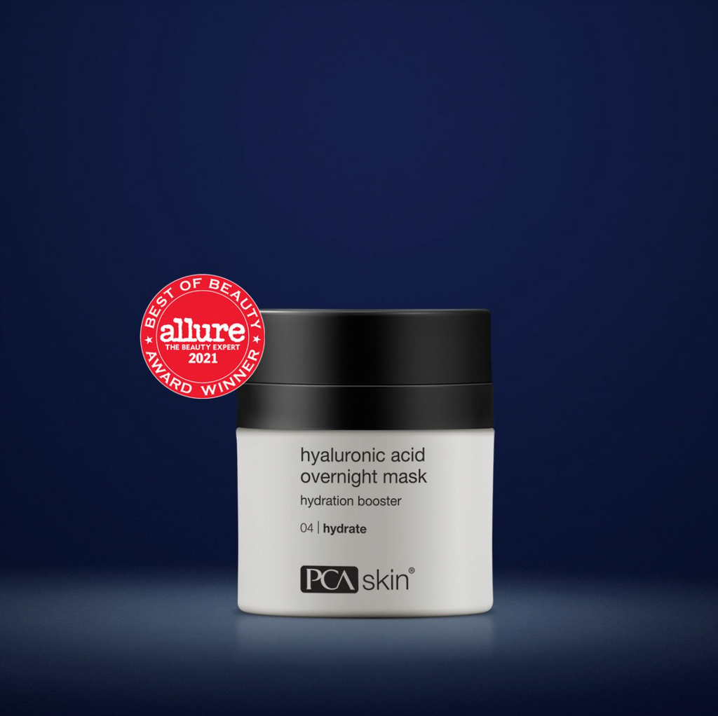 PCA Skin hyaluronic acid overnight mask in white container with black lid in front of a dark blue background