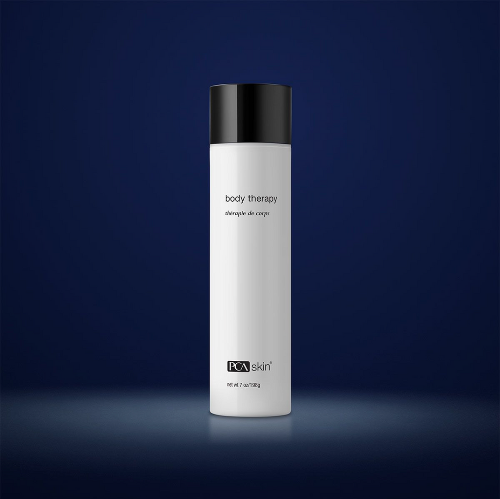 PCA Skin body therapy moisturiser in white bottle with black lid in front of dark blue background