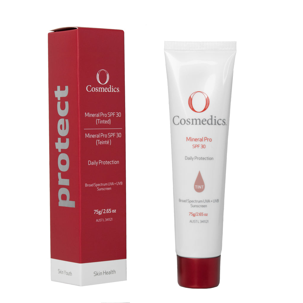 O Cosmedics mineral pro spf 30+ tinted in white container with red lid next to red packaging box in front of white background