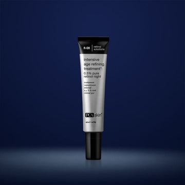 PCA Skin intensive age refining treatment in grey container with black lid in front of dark blue background