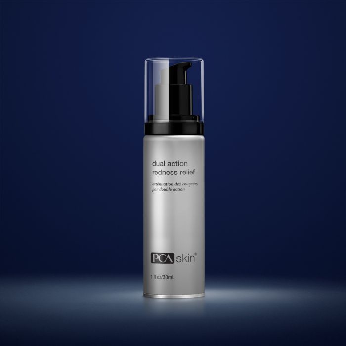 PCA Skin dual action redness relief in silver container with black lid in front of dark blue background