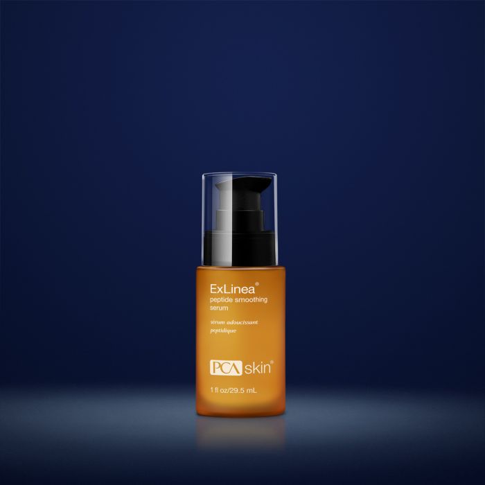 PCA Skin Exlinea peptide smoothing serum in orange container with black lid in front of dark blue background