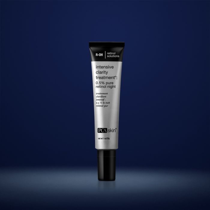 PCA Skin intensive clarity treatment in grey container with black lid in front of dark blue background